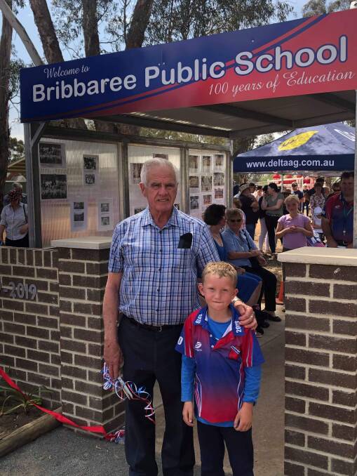 Former 1971 principal Bruce McAlister pictured with student Clay Ward after cutting the ribbon to the newly created centenary walkway.