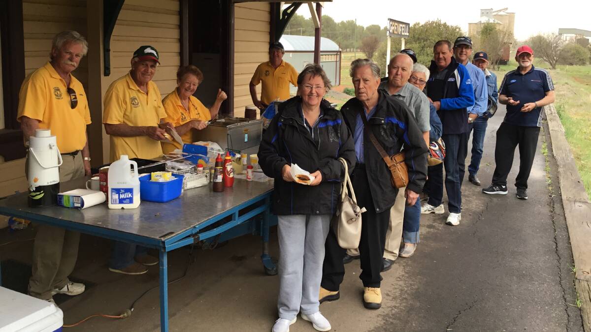 COOKING UP A (DUST) STORM: Grenfell Lions Club cooked a barbecue for the A Model Ford Club of NSW visitors. Photo: K Warburton.