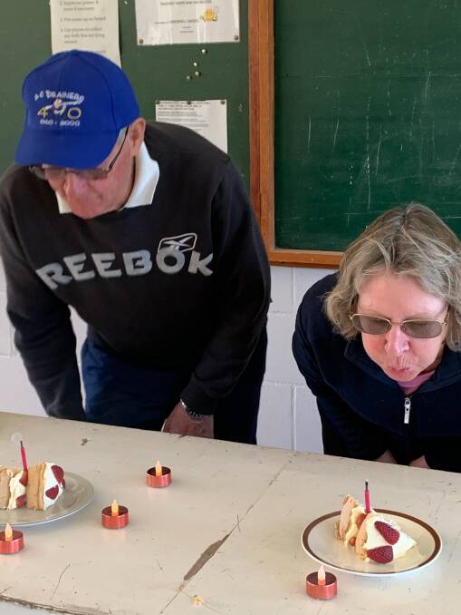 Arnold Brown and Ruth Stein blowing out the candles on the cup-cakes following social tennis. Photo: Cont.