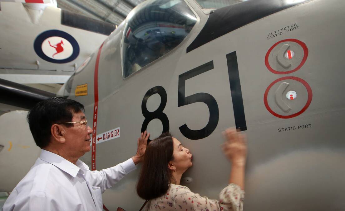 Jessica Chi Crosskill, with her father Tien Son Tran, pays her respects to the aircraft which led to her rescue 40 years ago.