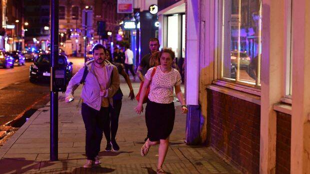People run down Borough High Street as police deal with a "major incident" at London Bridge.  Photo: PA