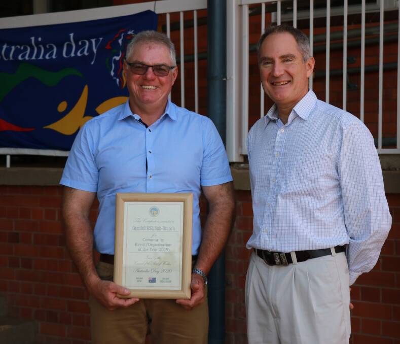 Grenfell RSL Sub Branch president Glen Ivins is congratulated by Australia Day Ambassador Andrew Lock. 