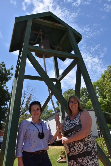 New librarian/Stage 3 teacher Hannah Robinson and new principal Michelle Morley at Grenfell Public School ringing the bell for a new school year this week.