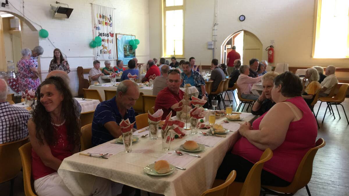 Guests and volunteers enjoying the Combined Churches Christmas luncheon. (Photo contributed).