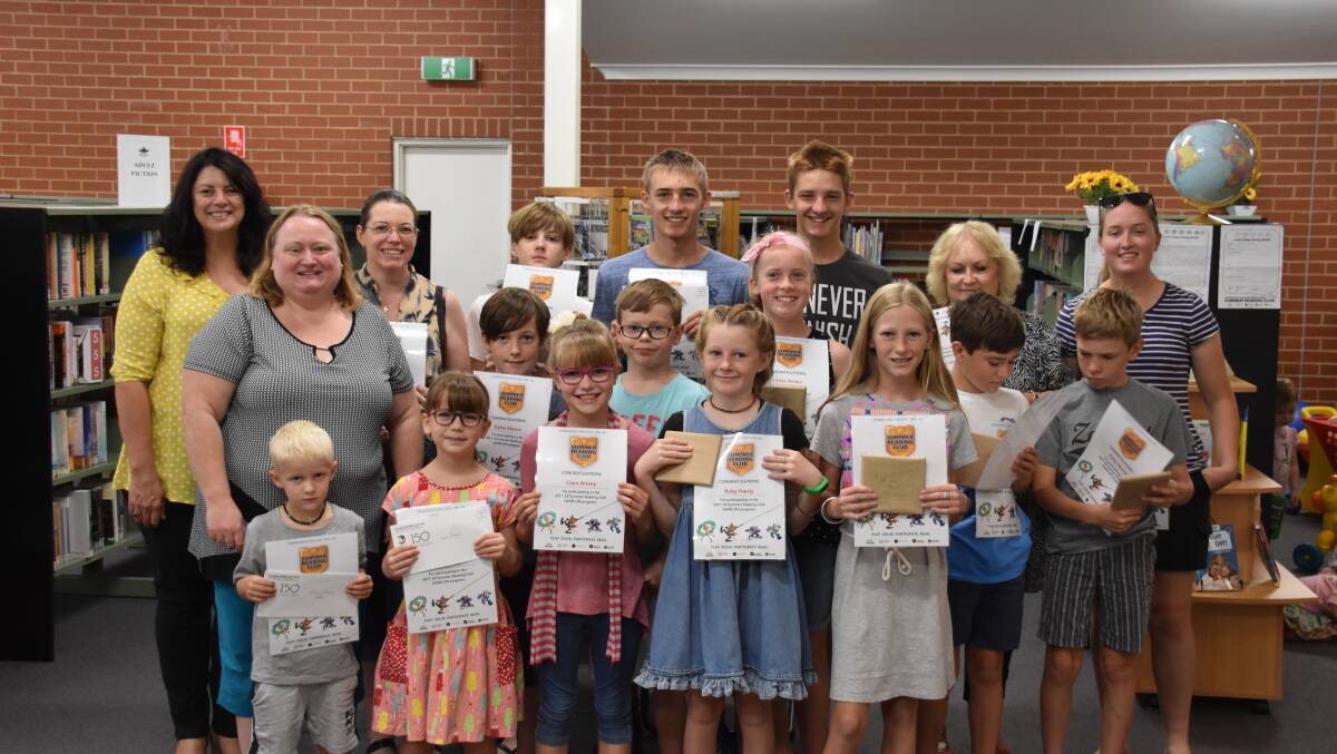 Councillor Carl Brown and librarian Erica Kearnes with summer reading club prize winners at the Grenfell Library last week.