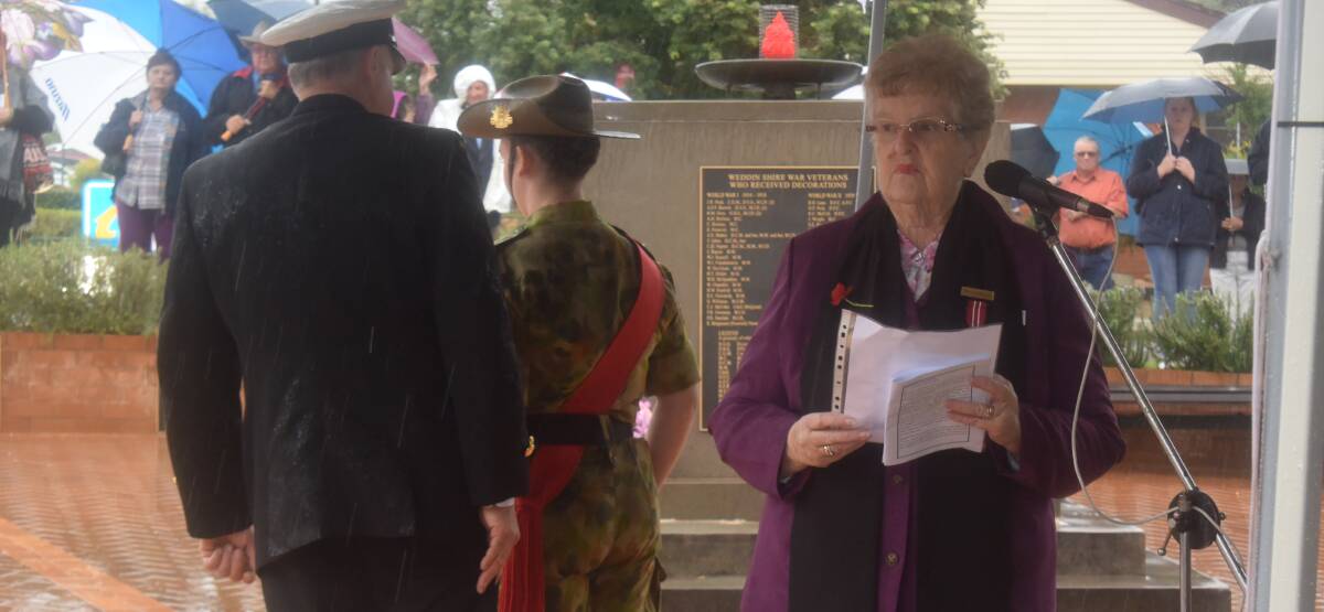 Grenfell RSL Chaplain Margaret Knight calls forward organisations for the wreath laying ceremony at the Anzac Day Service in Memorial Park.