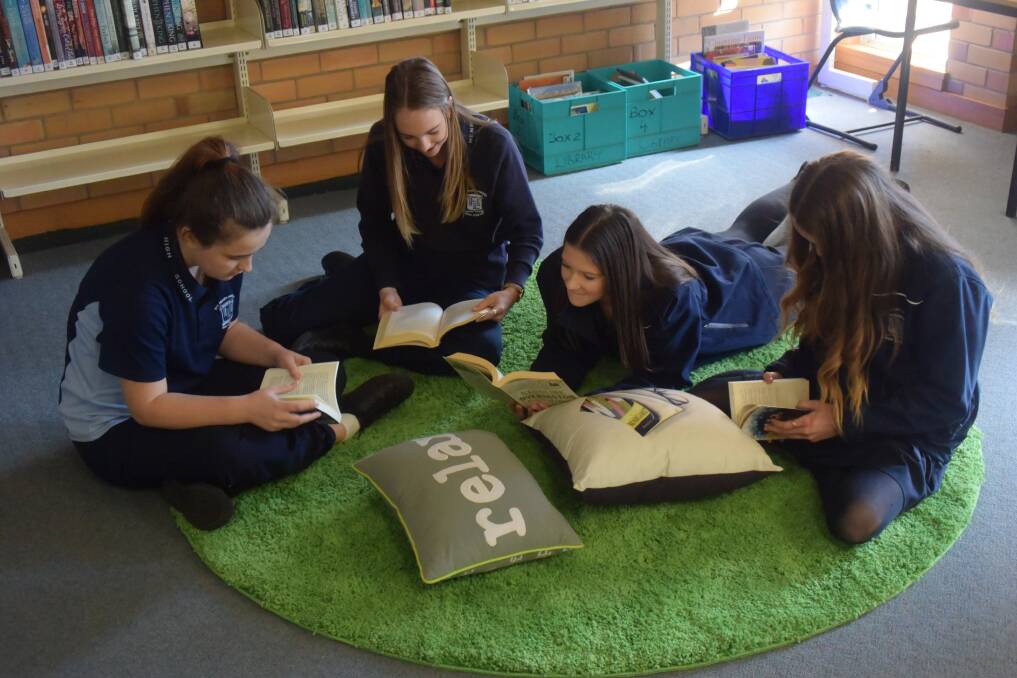 Kyrstye Henry, Natalie Cotter, Sarah Debritt-Frost and Maya Squires reading on the super soft new rugs.