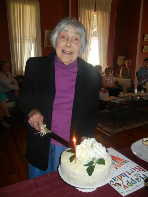  Roma Sinclair cutting her 90th birthday cake. 