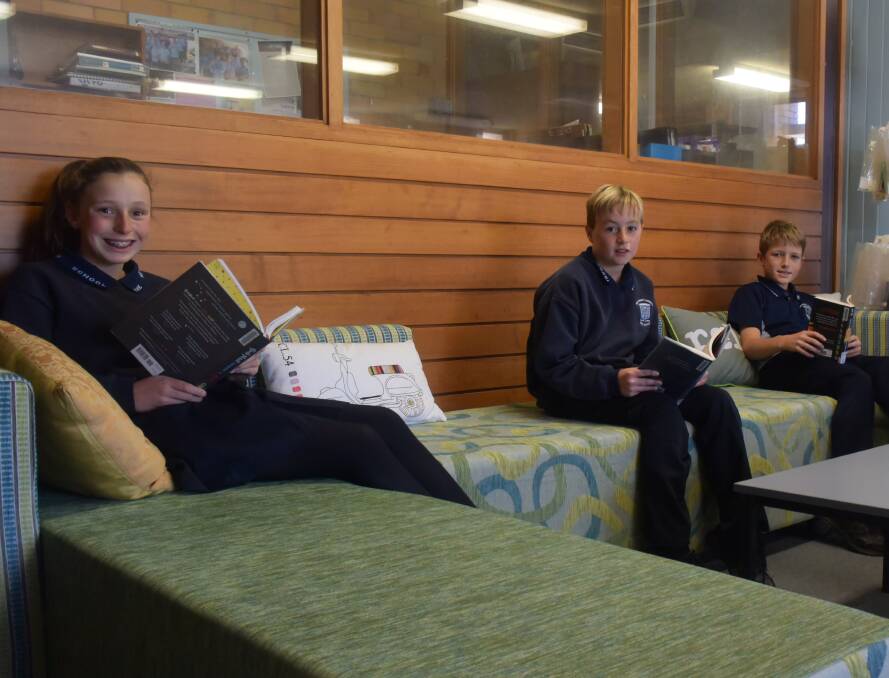 Nikki Chalker, Angus Troth and Oliver Taylor taking in a good book on the new sofa.