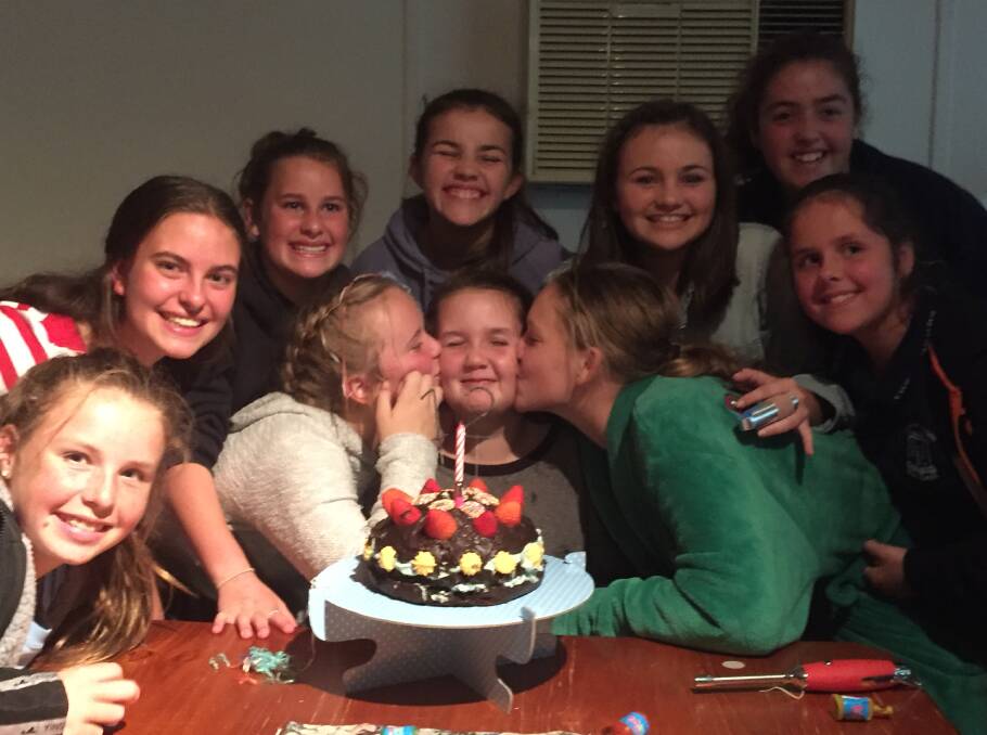 Megan Wilson (being smothered with kisses) with good friends celebrating her 12th birthday.