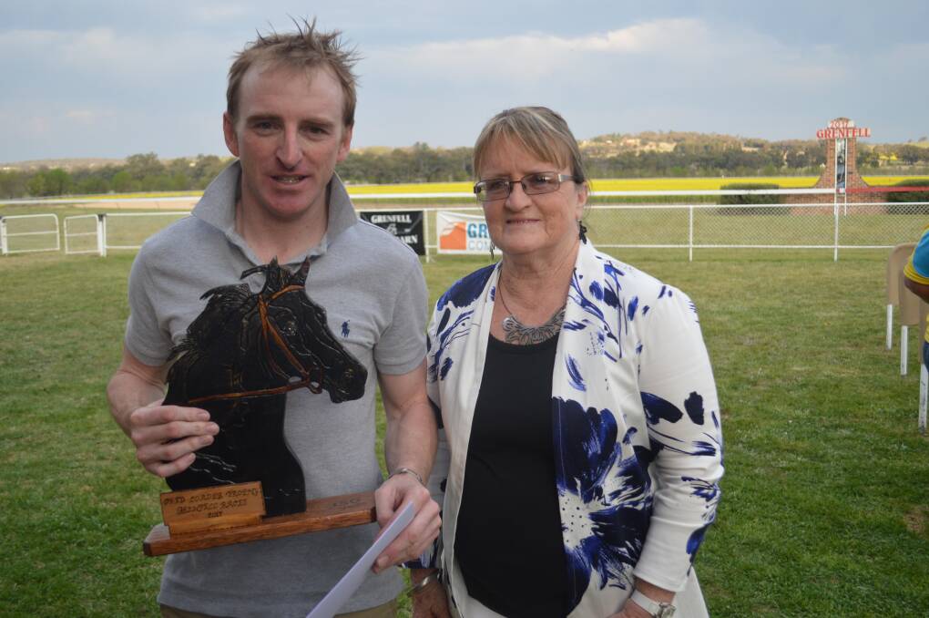 Leading Jockey Simon Miller being presented with the 'Fred Loader Memorial Trophy' by Karen Loader.