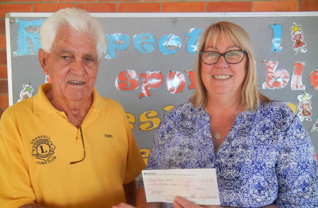 Lion Terry Carroll presenting GPS Principal Michele Morley with a cheque for Presentation Day Awards. 