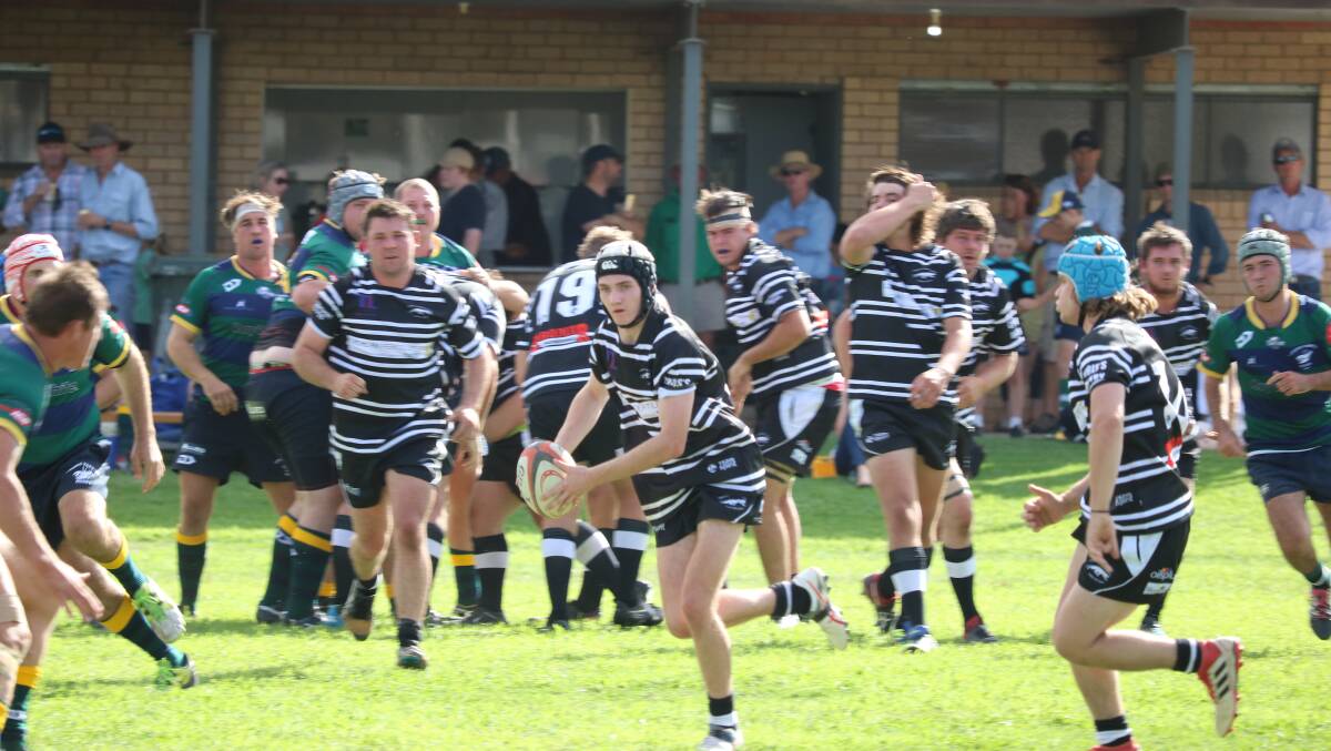 Grenfell Panther Frazer Ryder offloads to his teammate in last Saturday's 10 all clash with the Young Yabbies. Photo Carly Brown
