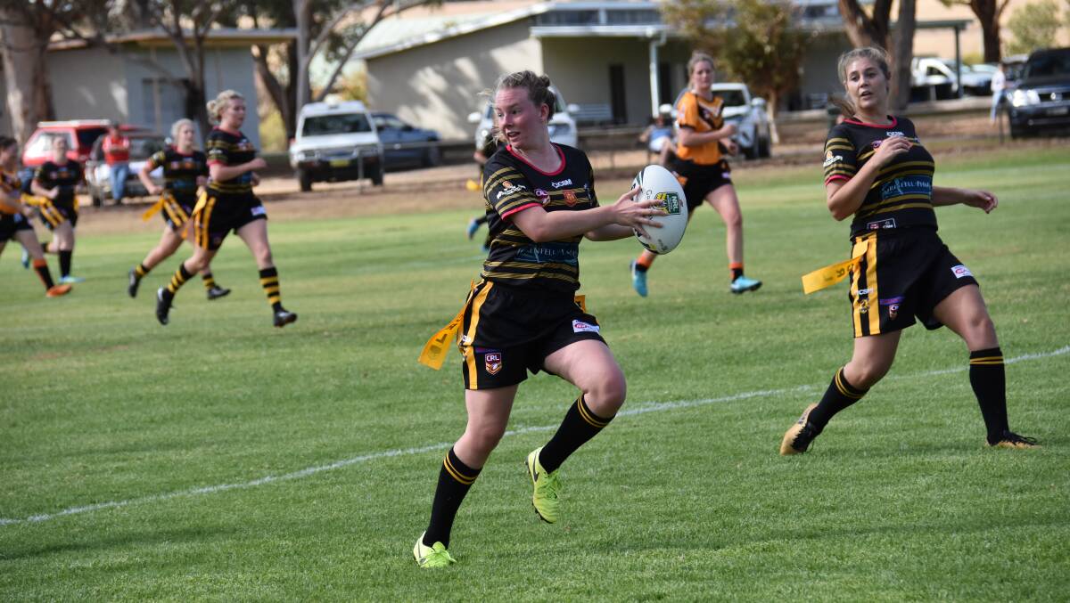 Girlanna Isabel Holz offloads during a recent clash at Lawson Oval. 