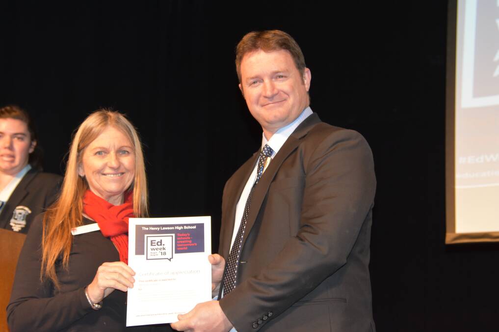 Elly Schiller from Grenfell Community Health receiving a community award from THLHS principal Ian Pattingale. 