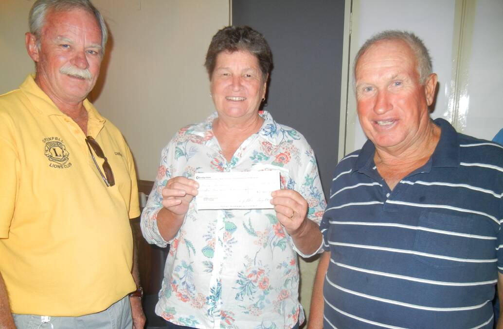 Jenny and Ian Armstrong receive a cheque on behalf of their son David.