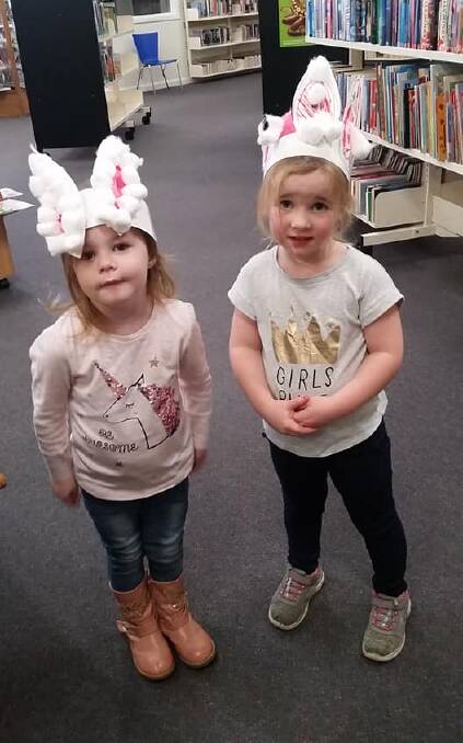 These two adorable little bunnies are proud of their Easter hat masterpieces. Photo Grenfell Library 