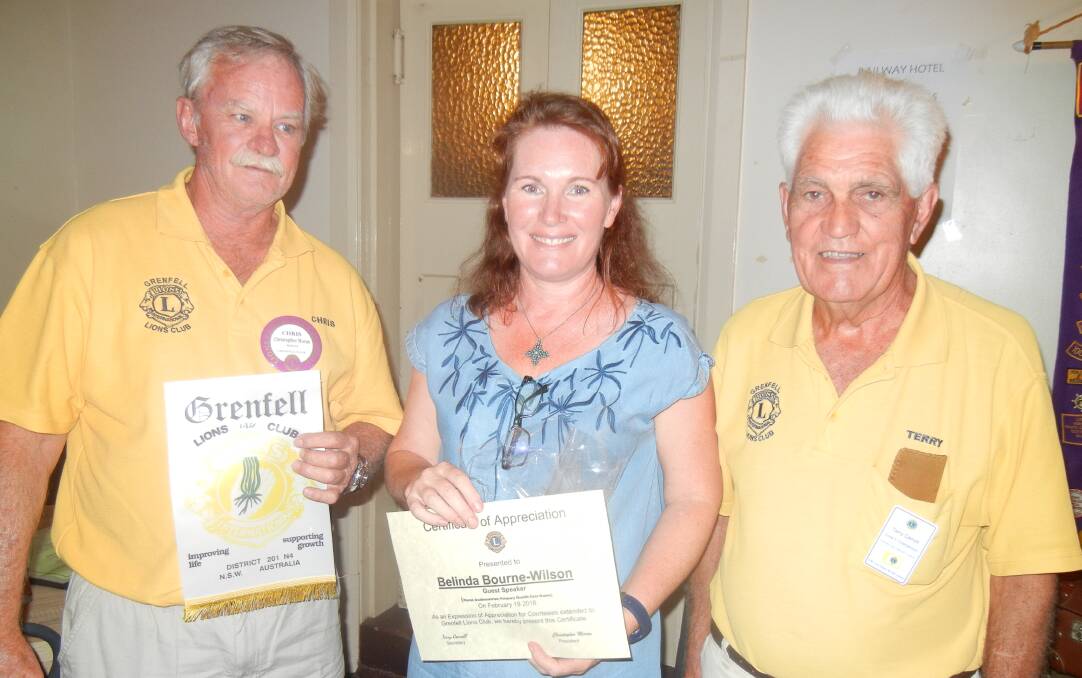 Lions Chris Moran and Terry Carroll present Belinda Wilson with a gift. 