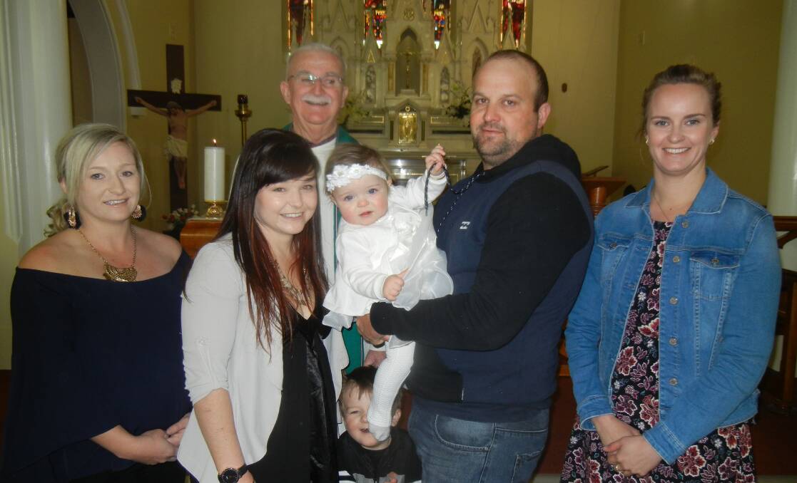 Amarlie with her Godparents Alicia White & Rachael Hewen, her parents, brother Nixon and Fr Crowe. 