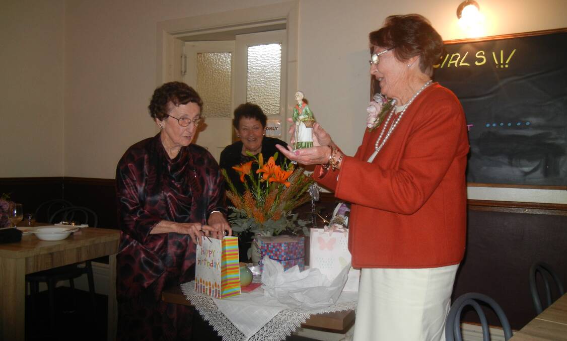 Margaret Thorncraft and Patricia Reid presenting Coral Mitton with some gifts at her 80th birthday.