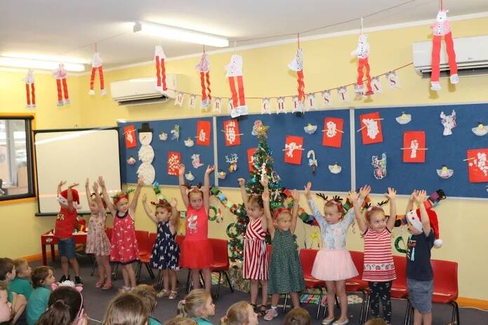 Preschool children entertaining the crowd with a Christmas song.