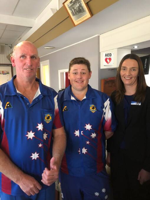 Major Pairs Champions Andrew Armstrong and Blake Bradtke are presented with their badges by Grenfell Bowling Club manager Bianca Hughes. Photo supplied. 