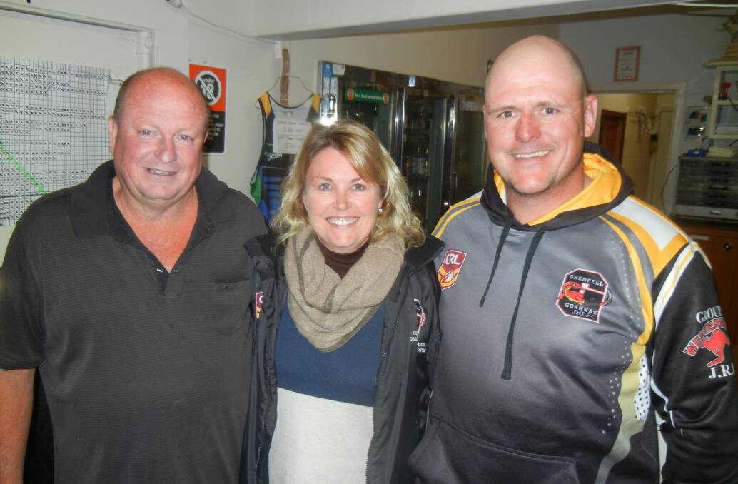 Grenfell Junior Rugby League officials Isabel Holmes and Matt Reid with Lyle Walker (L). Lyle is being presented with "Life Time Supporters" Shirt for his many years of sponsorship to the club.