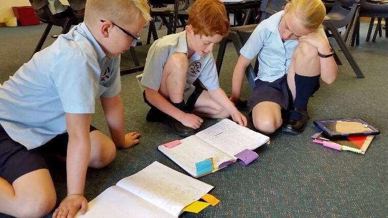 Braydon, Charlie and Sophie working on their peer editing as part of the publishing cycle. Photo St Joseph's PS.