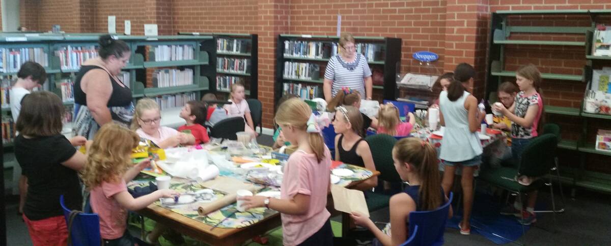 Children having a fantastic time during the library's school holiday craft sessions. Photo supplied