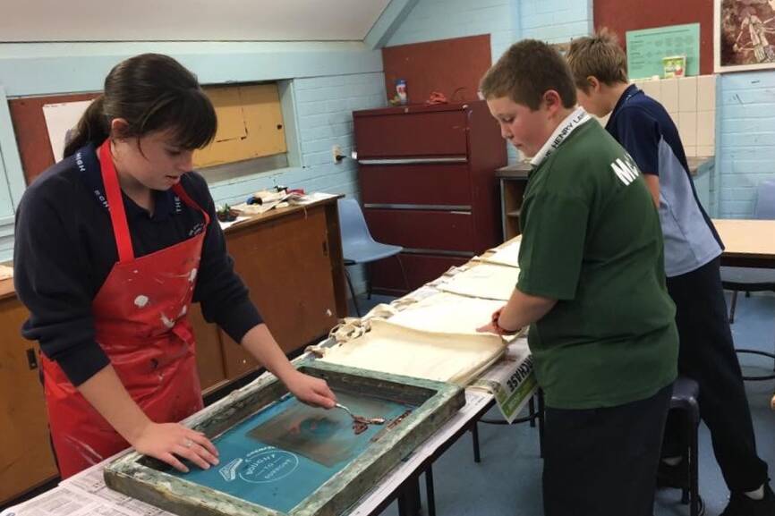 Art students at THLHS are busy screen printing logos onto the pre-made cloth bags. Photo H Carpenter.