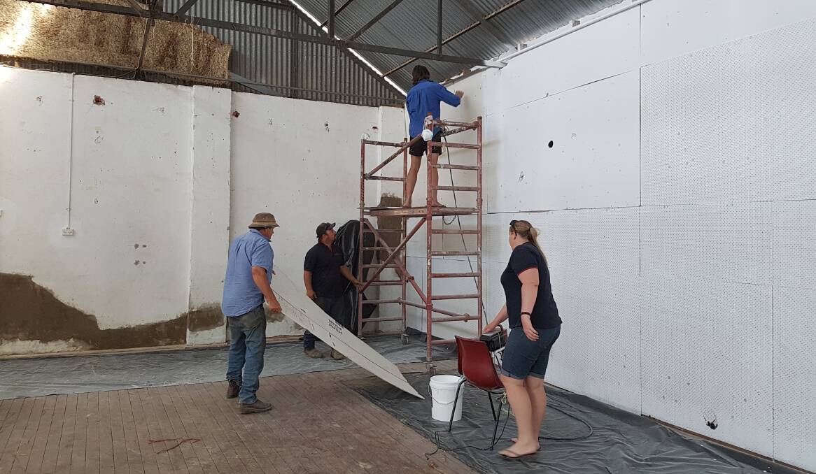 Show Society volunteers give the Grenfell Showground's Simpson Pavilion a face lift. Photo L Eastaway.
