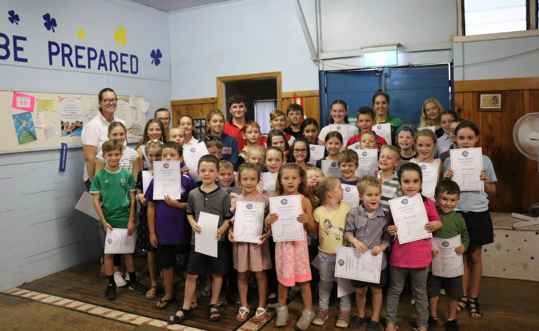 Grenfell Swimming Club members receiving their club championship participation certificates. Image supplied