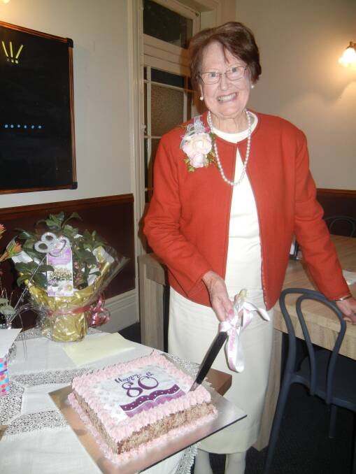Coral Mitton cutting her 80th birthday cake. 