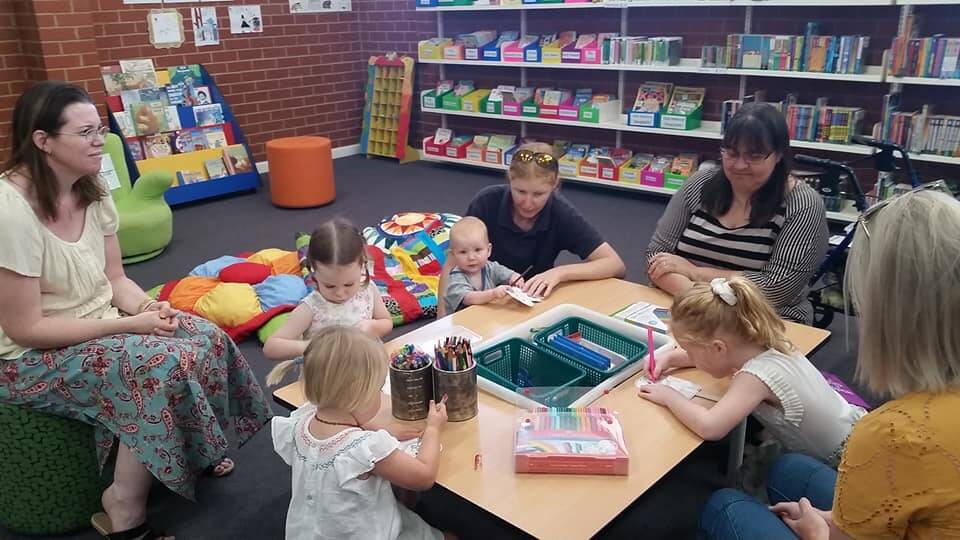 Children and parents enjoy arts and craft time in the vibrant new children's corner of the Grenfell Library. Image supplied