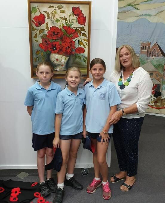 Grenfell Public School students Ruby Hardy, Daisy McMahon and Ella Mitton with Garden Club president Chris Lobb last Friday at the local Art Gallery. Image supplied 