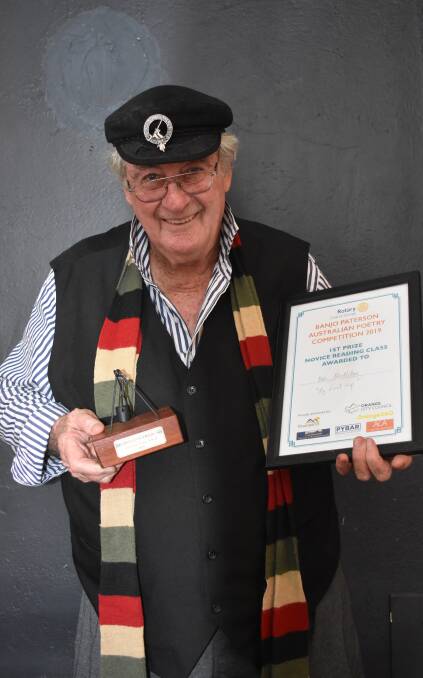 Local poet Bob McMillan proudly holds his winning trophy and certificate. 