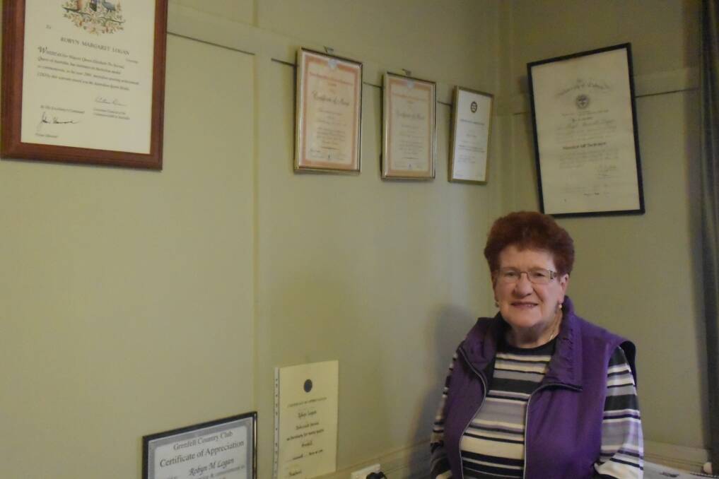 Robyn Logan with just a few of her certificates of achievement. 