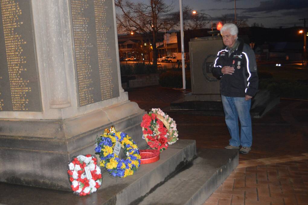Terry Carroll lays a wreath at the Long Tan Day service.