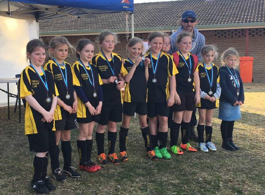 The Grenfell girls soccer team that competed at the Cowra gala day last weekend with coach Gavin Johnson. Photo T Taylor.