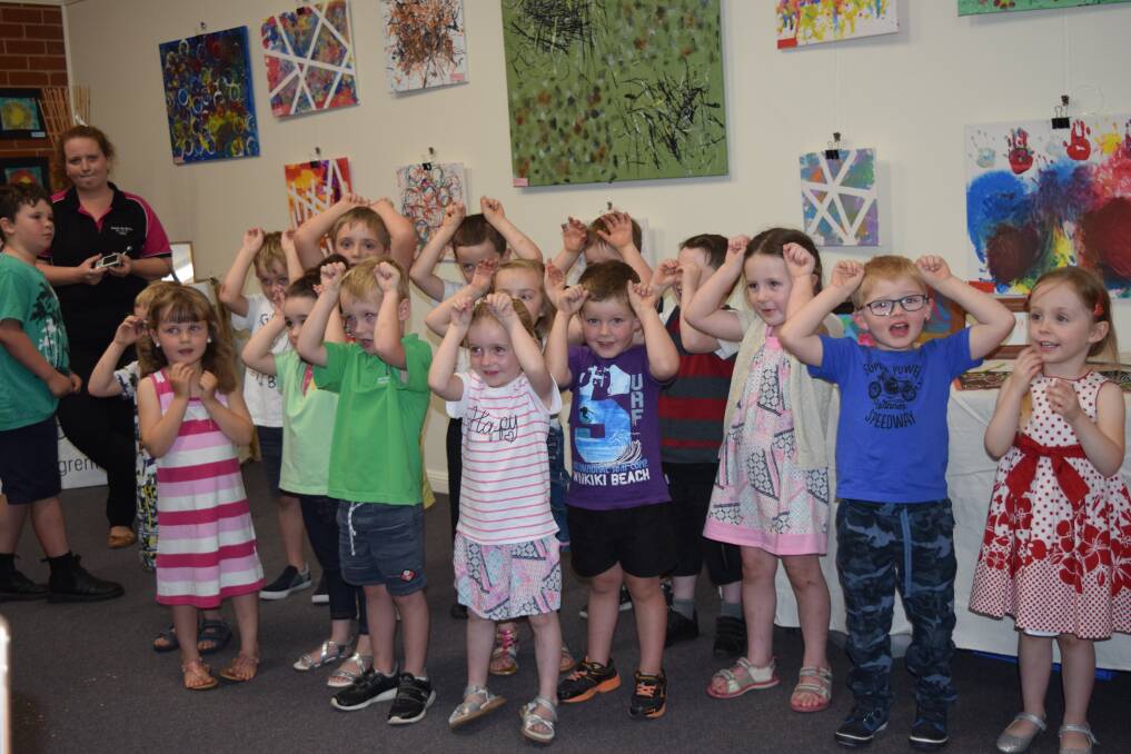 Children from the Pre-school room singing at the art show.