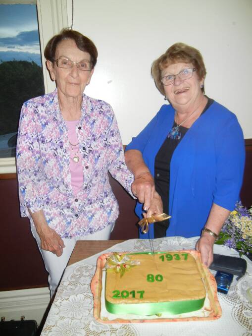 Fay Hancock  (L) and Joan Eppelstun cutting the 80th birthday cake. 