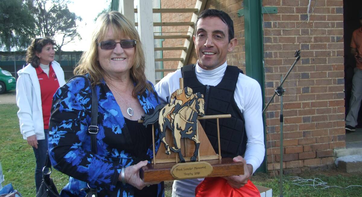 Karen Loader is pictured here presenting Tony Cavallo with the Fred Loader Memorial Trophy for Most Successful Jockey at the 2015 race day.