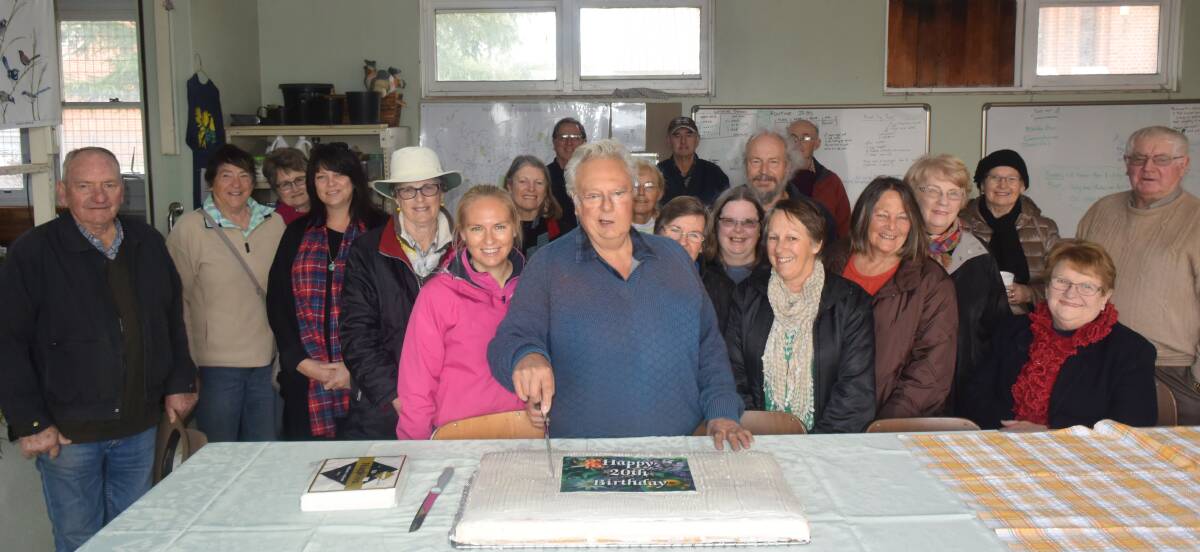 Noel Cartwright cuts the 20th birthday cake during the Endemic Garden's milestone celebrations last Wednesday at the WCNN.