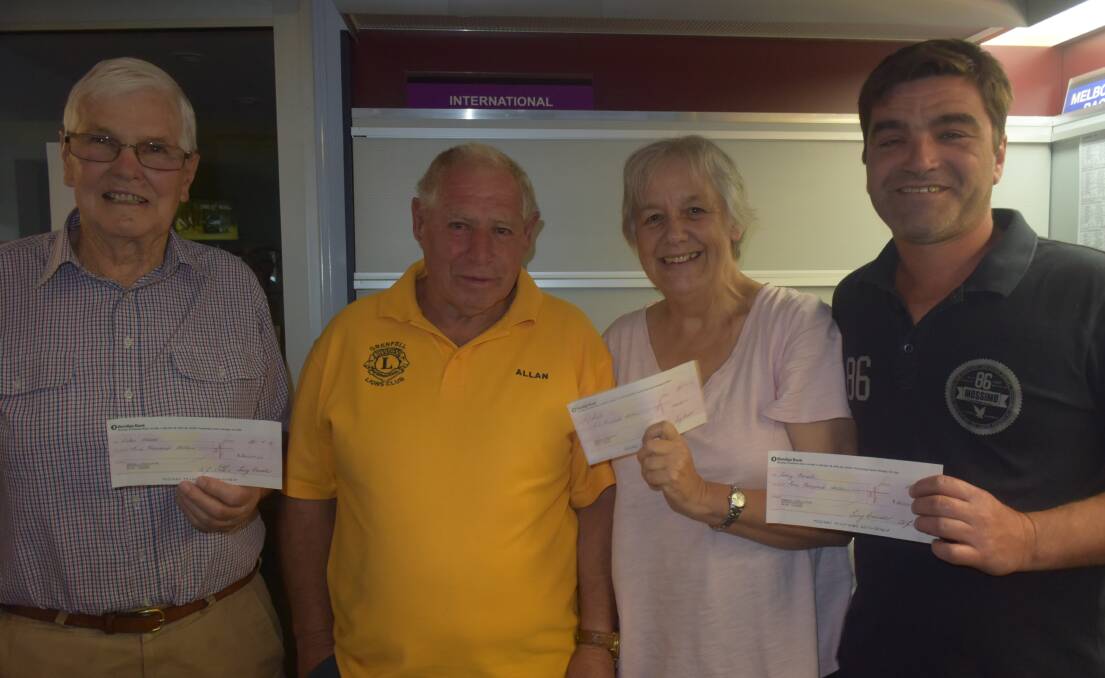 Happy Mini Lotto winners, Colin Wood, Liz Smith and Corey Fenech receiving their vouchers from Lions Treasurer Allan Stokes. 