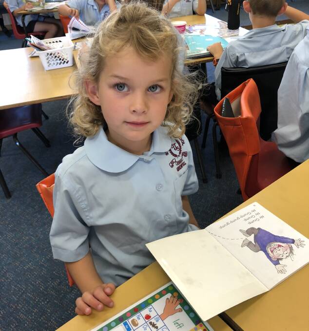 Kindergarten student Saskia McLelland during reading time. Photo St Joseph's.