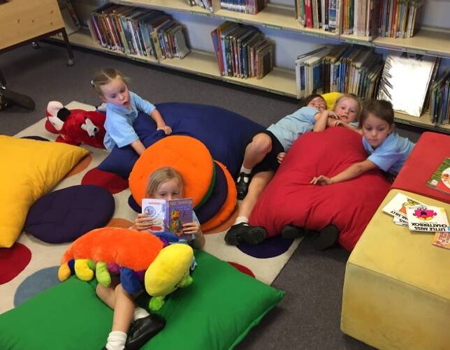  Kindergarten students relaxing in the library. Photo GPS