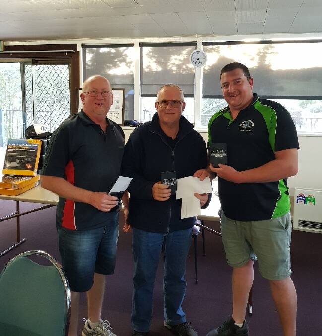Coming in third were Michael Neill, Denis and Lance Smith, pictured with Doug Kohnan receiving their prize. Image supplied 