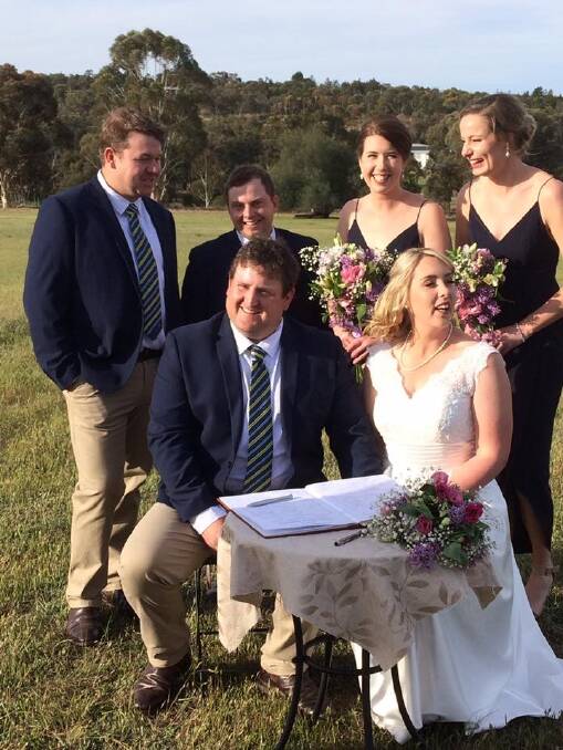 Karl Makin and Alex Hamilton signing the marriage register pictured with their attendants. 