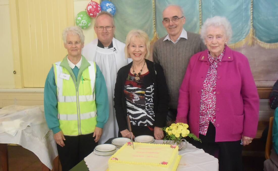 Members of the Grenfell Food Hall committee cutting the first birthday cake this time one year ago. 