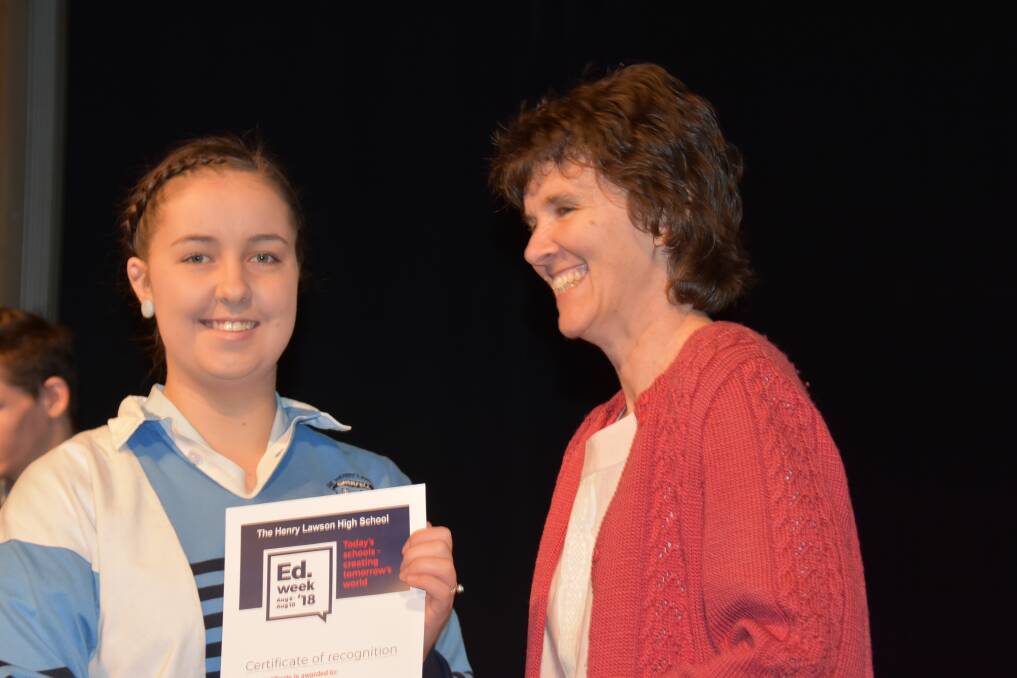 Abby Joyce receiving a certificate for her outstanding work placement at THLHS from P&C president Beth Knight.